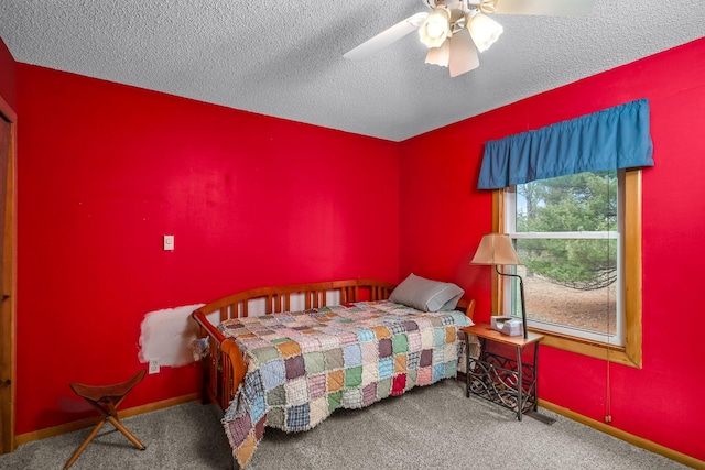 bedroom featuring a ceiling fan, carpet floors, a textured ceiling, and baseboards