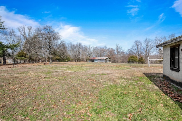 view of yard featuring fence and a rural view