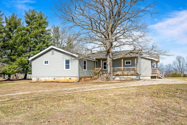 view of front of home with a porch, a front yard, and crawl space