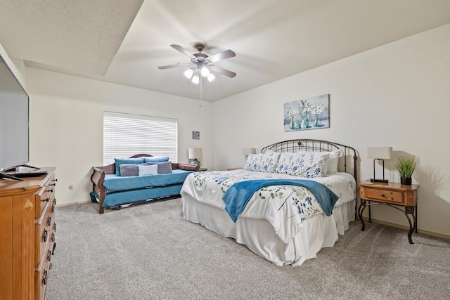 carpeted bedroom with ceiling fan and baseboards