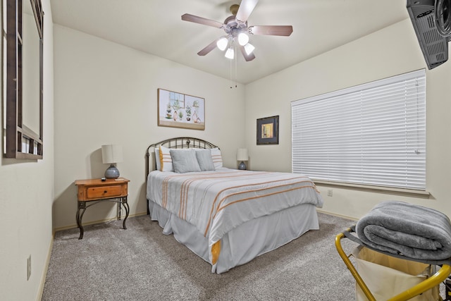 carpeted bedroom featuring baseboards and a ceiling fan