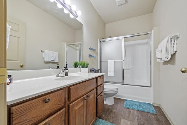 full bathroom featuring enclosed tub / shower combo, toilet, wood finished floors, visible vents, and vanity