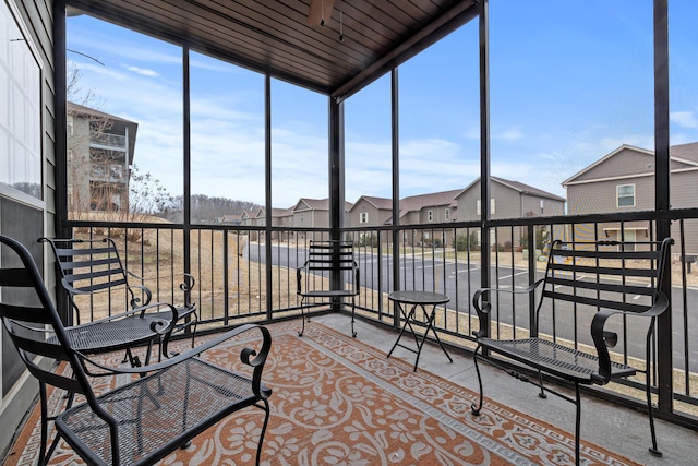 sunroom / solarium featuring a residential view