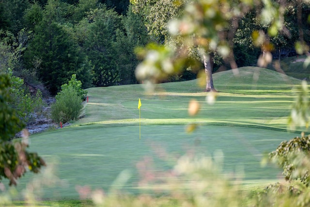 view of tennis court with a lawn