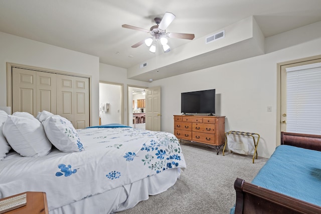 bedroom with a closet, visible vents, ceiling fan, and carpet flooring