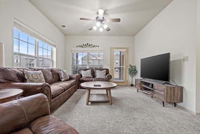 carpeted living room featuring a ceiling fan, baseboards, visible vents, and a wealth of natural light