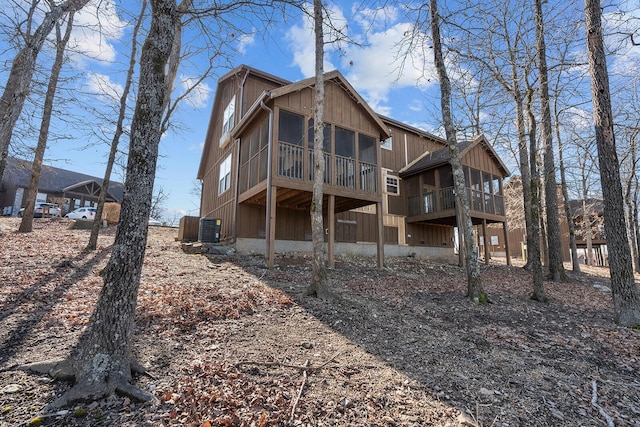 rear view of house featuring a sunroom and central AC unit