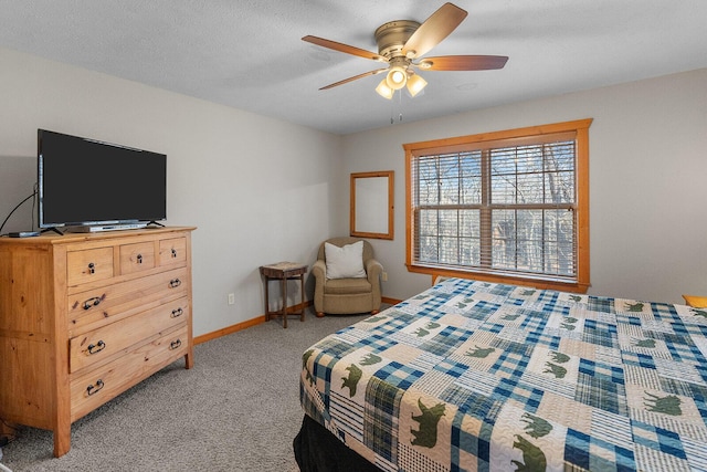 bedroom featuring light carpet, ceiling fan, a textured ceiling, and baseboards