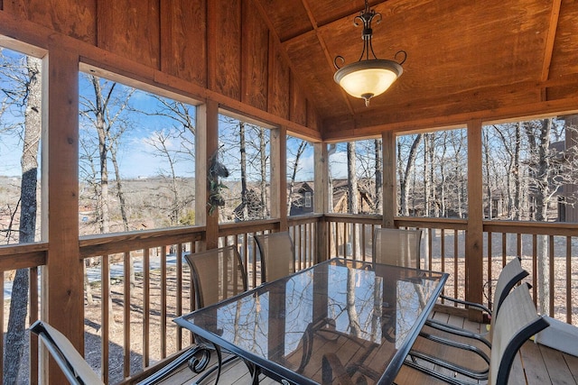 sunroom with vaulted ceiling and wood ceiling