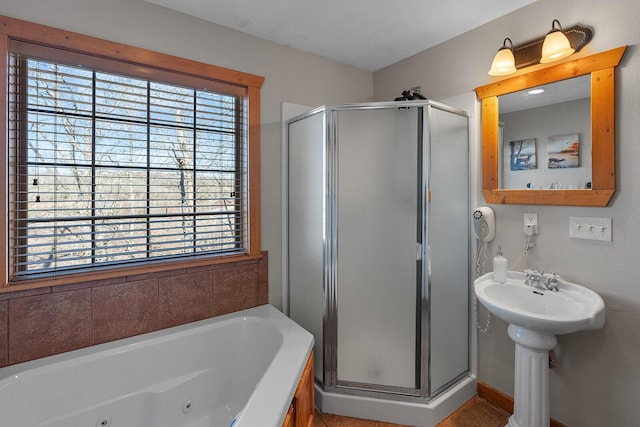 full bath featuring a jetted tub and a shower stall