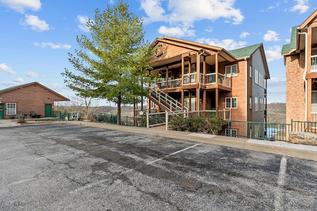 view of building exterior with uncovered parking