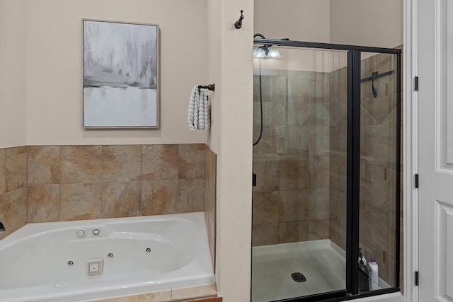 bathroom with a tub with jets and a shower stall