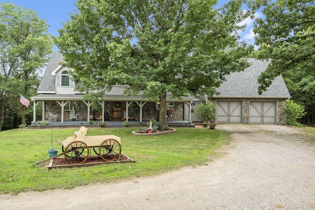 view of front of property with stone siding, a front yard, a porch, and roof with shingles