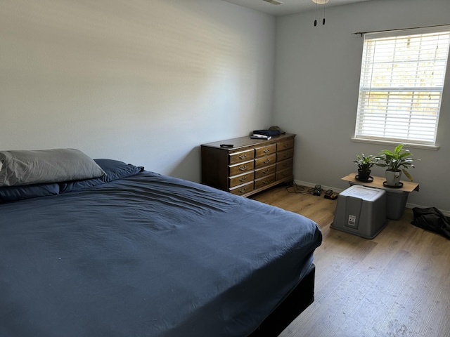 bedroom featuring light wood-type flooring and baseboards