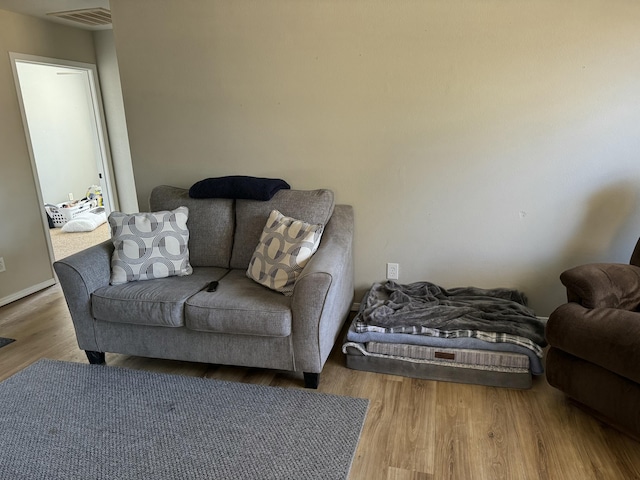 living room featuring wood finished floors and visible vents