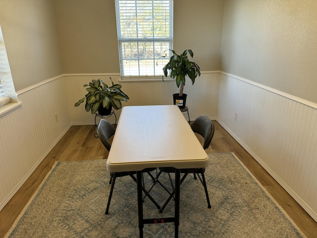 office area with a wainscoted wall and wood finished floors