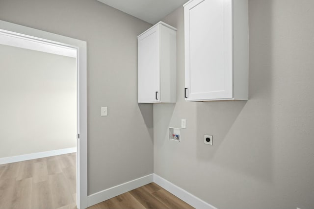 laundry area with wood finished floors, baseboards, hookup for an electric dryer, cabinet space, and washer hookup