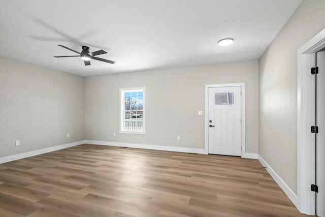 foyer featuring baseboards, a ceiling fan, and wood finished floors