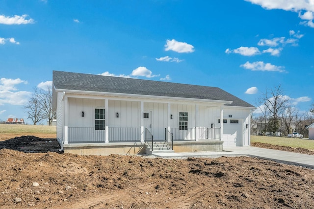 view of front of house featuring driveway, a porch, board and batten siding, an attached garage, and a shingled roof