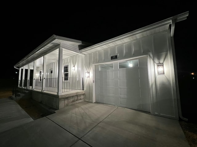 view of front of property featuring a porch, concrete driveway, board and batten siding, and an attached garage