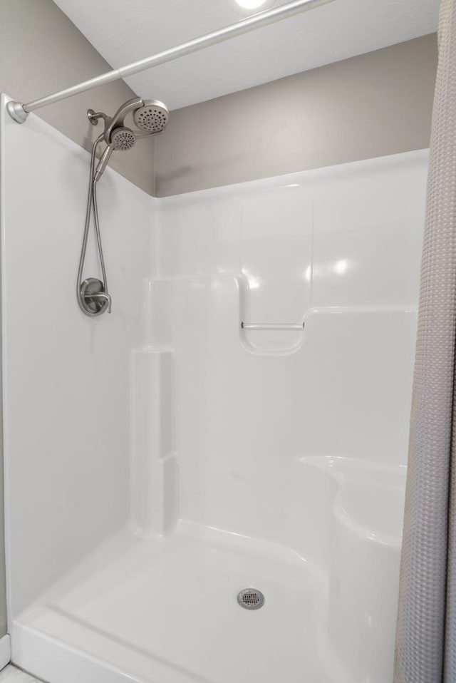 bathroom with a shower stall