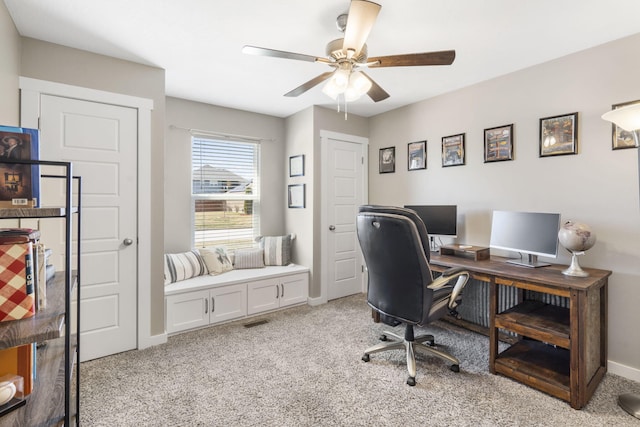 office featuring light carpet, visible vents, baseboards, and a ceiling fan