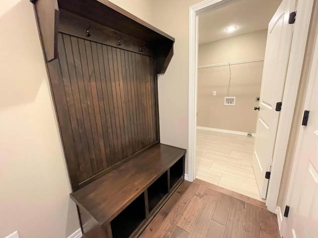 mudroom featuring baseboards and wood finished floors