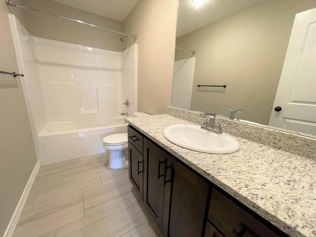 bathroom featuring baseboards, shower / bath combination, vanity, and toilet