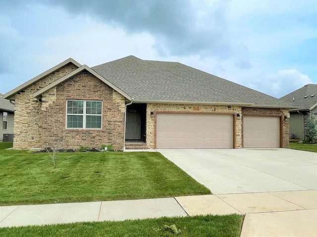 view of front of home with a shingled roof, concrete driveway, an attached garage, a front lawn, and brick siding