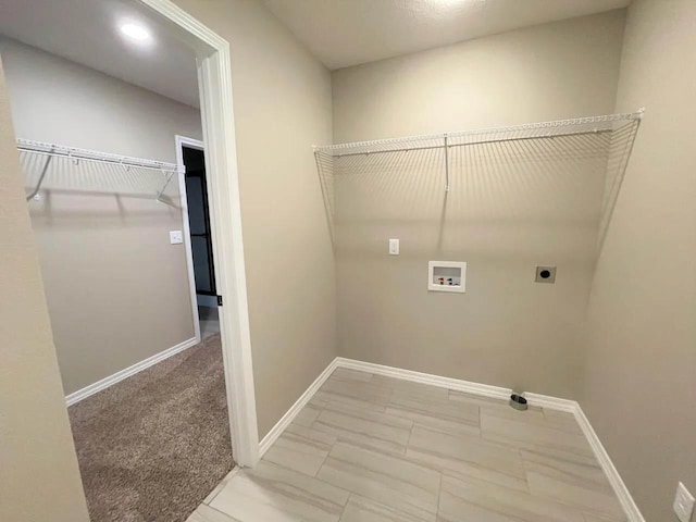 laundry area featuring laundry area, hookup for a washing machine, baseboards, and electric dryer hookup