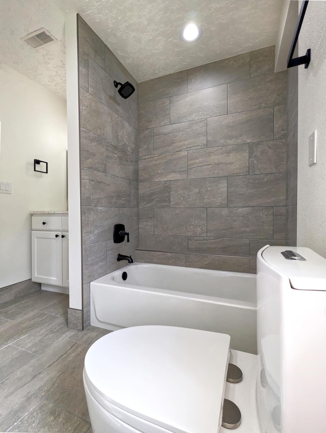 bathroom featuring visible vents, a textured ceiling, toilet, and tub / shower combination