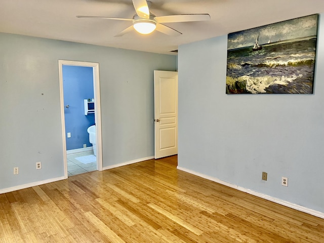 109 Lancashire Dr, Branson, MO 65616 - unfurnished bedroom with connected bathroom, baseboards, ceiling fan, and wood finished floors