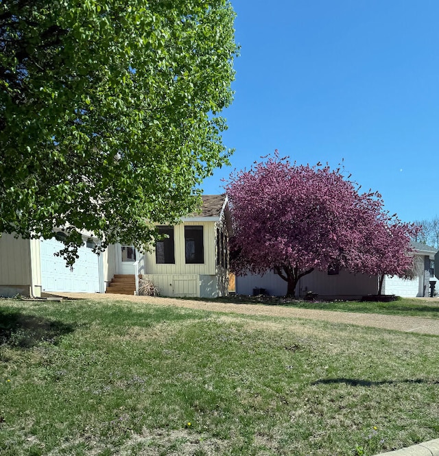 109 Lancashire Dr, Branson, MO 65616 - view of property hidden behind natural elements with an attached garage and a front yard