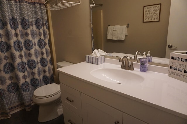 bathroom featuring curtained shower, vanity, and toilet