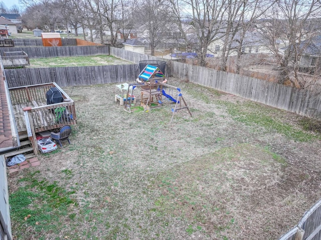 view of yard featuring a playground and a fenced backyard