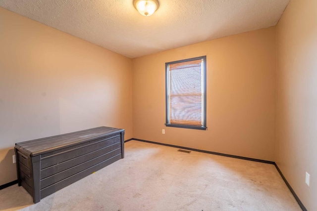 interior space with visible vents, baseboards, and a textured ceiling