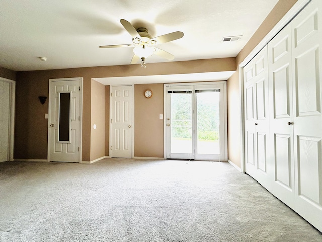 interior space with a ceiling fan, carpet, visible vents, and baseboards