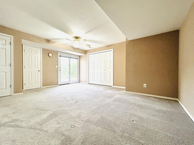 unfurnished bedroom featuring ceiling fan, carpet floors, access to outside, and baseboards