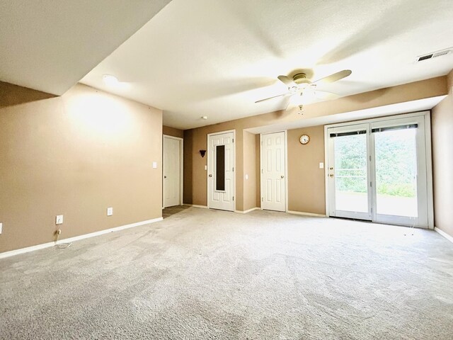 unfurnished room with baseboards, visible vents, a ceiling fan, and light colored carpet