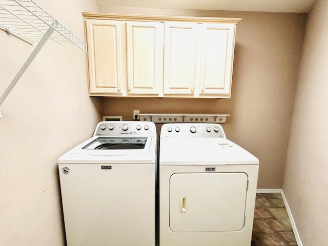 laundry area featuring independent washer and dryer, cabinet space, and baseboards