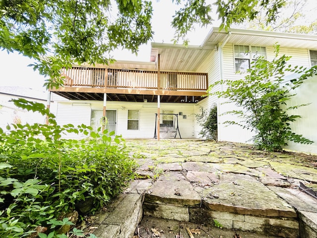 back of house featuring a wooden deck