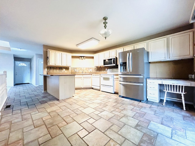 kitchen with light countertops, visible vents, backsplash, appliances with stainless steel finishes, and a sink