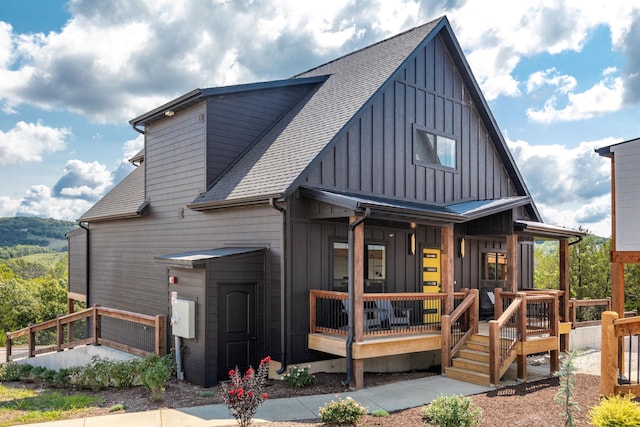 view of front of property featuring board and batten siding and a shingled roof