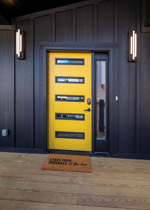 view of exterior entry featuring board and batten siding