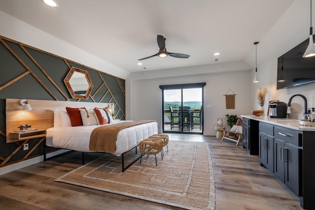 bedroom with ceiling fan, wood finished floors, access to exterior, a sink, and recessed lighting