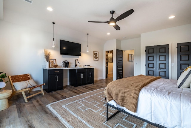 bedroom with light wood-style flooring, a sink, and recessed lighting