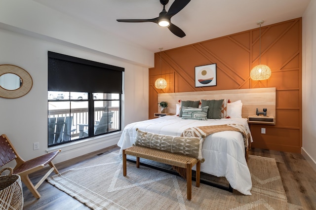 bedroom with visible vents, ceiling fan, and wood finished floors