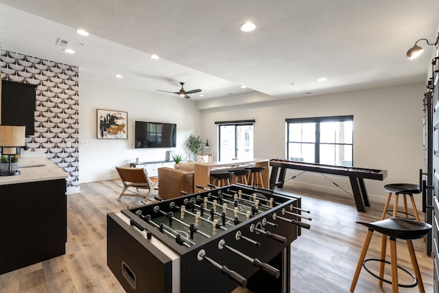 playroom with light wood-type flooring, ceiling fan, baseboards, and recessed lighting