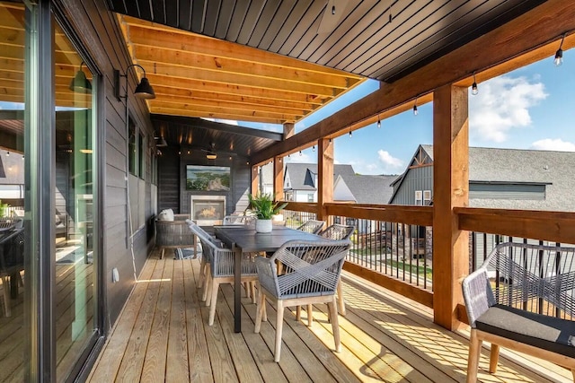 wooden terrace featuring outdoor dining space