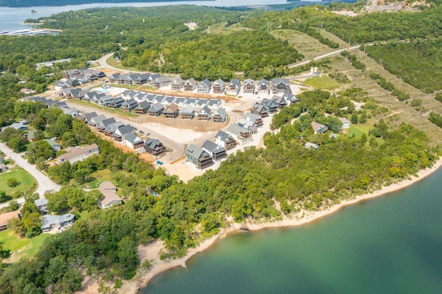 aerial view with a water view, a wooded view, and a residential view